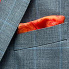 Breast pocket of light gray with light blue windowpane sport coat with built-in pocket square holder and hand-finished edges