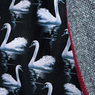 Detail of black swan-patterned lining with maroon piping accent showing through front vents