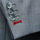 Detail shot of suit jacket sleeve showing functional buttonholes with light grey horn buttons