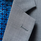 Detailed view of notch lapel on light grey sharkskin suit jacket