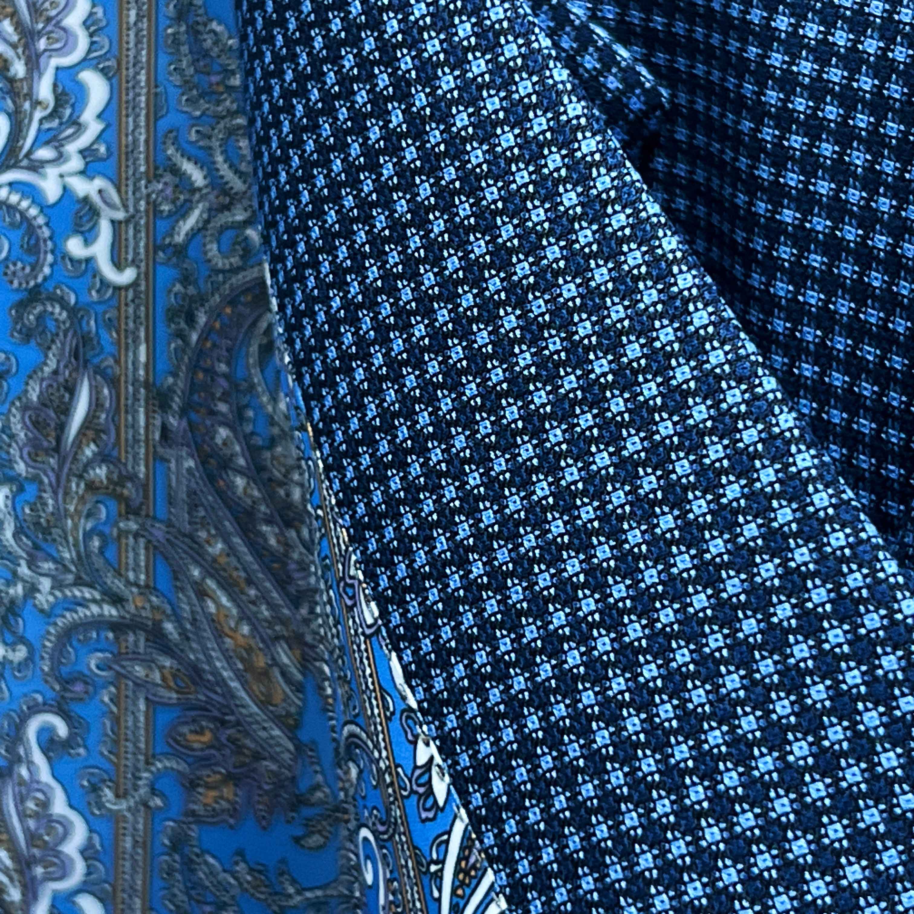 Close-up of Super 120s Australian merino wool fabric showing medium blue base with navy micro check geometric pattern