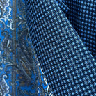 Close-up of Super 120s Australian merino wool fabric showing medium blue base with navy micro check geometric pattern