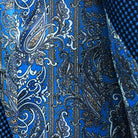 Colorful flash lining detail visible at jacket cuffs and vents in blue, white and gold paisley pattern