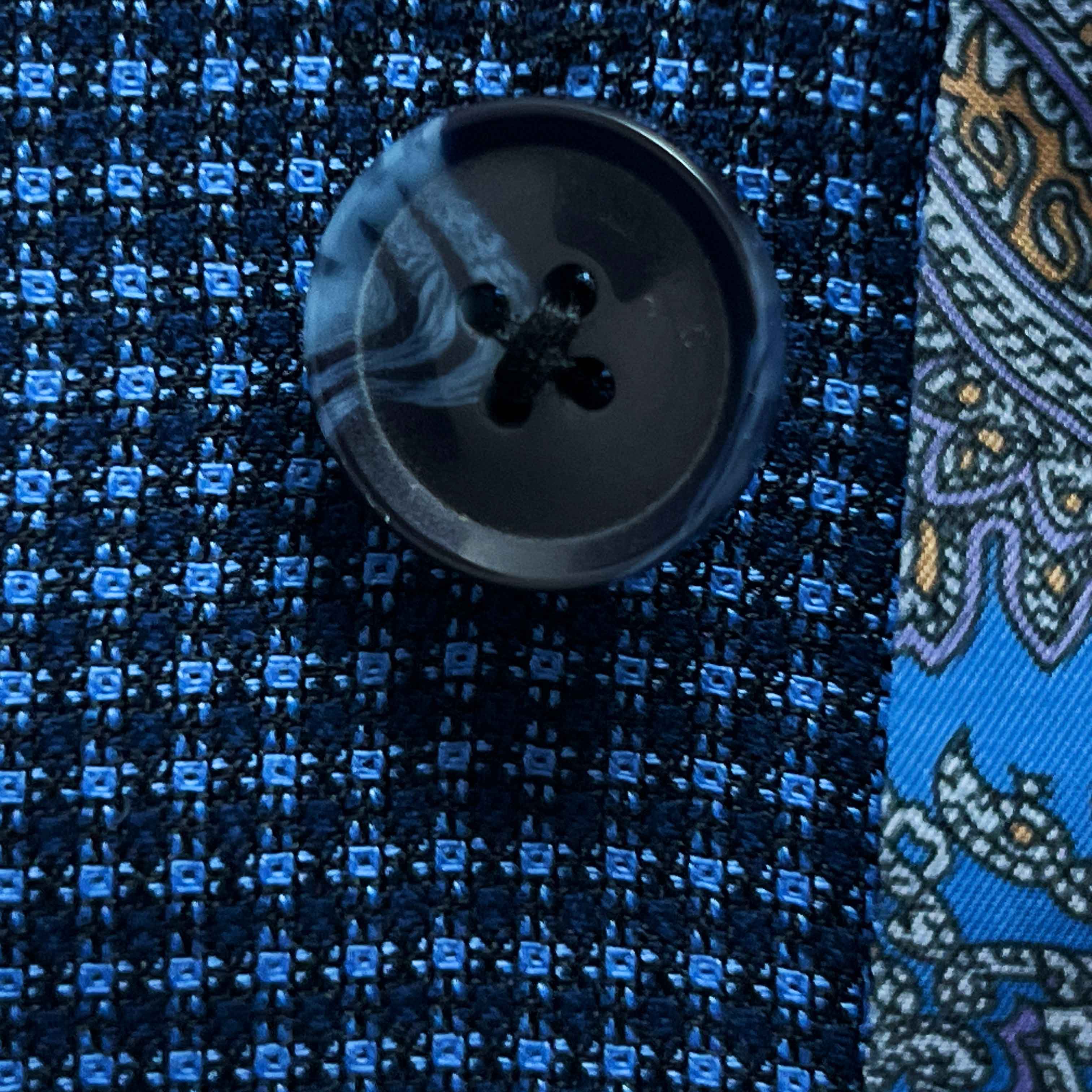 Close-up of navy marbled horn buttons on medium blue micro check sport coat showing natural patterns