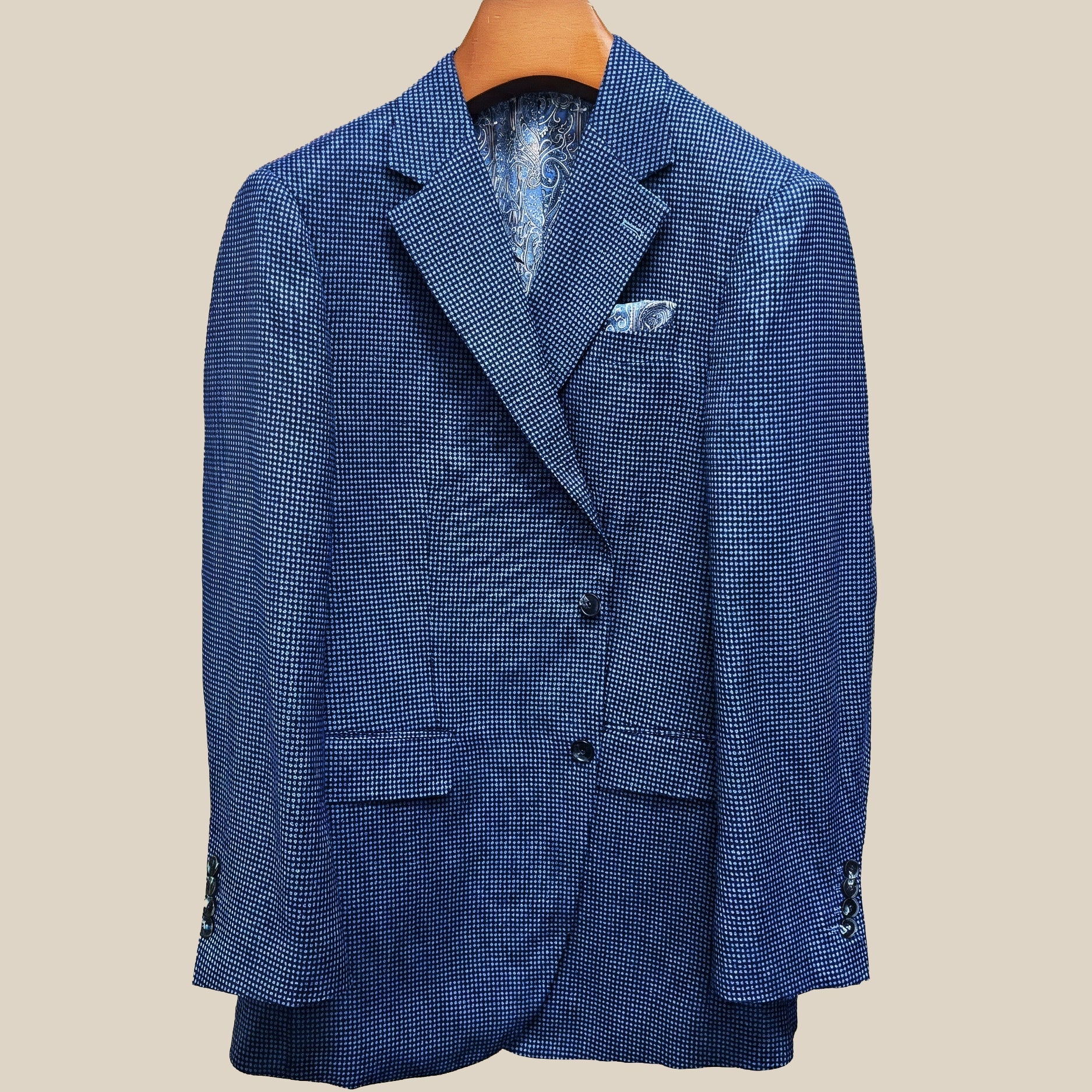 Front button panel of medium blue micro check sport coat featuring navy marbled horn buttons and hand pick stitching