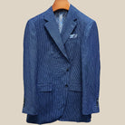 Front button panel of medium blue micro check sport coat featuring navy marbled horn buttons and hand pick stitching