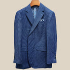 Close-up view of medium blue micro check sport coat showing contrast light blue accent buttonhole with hand-finished stitching detail