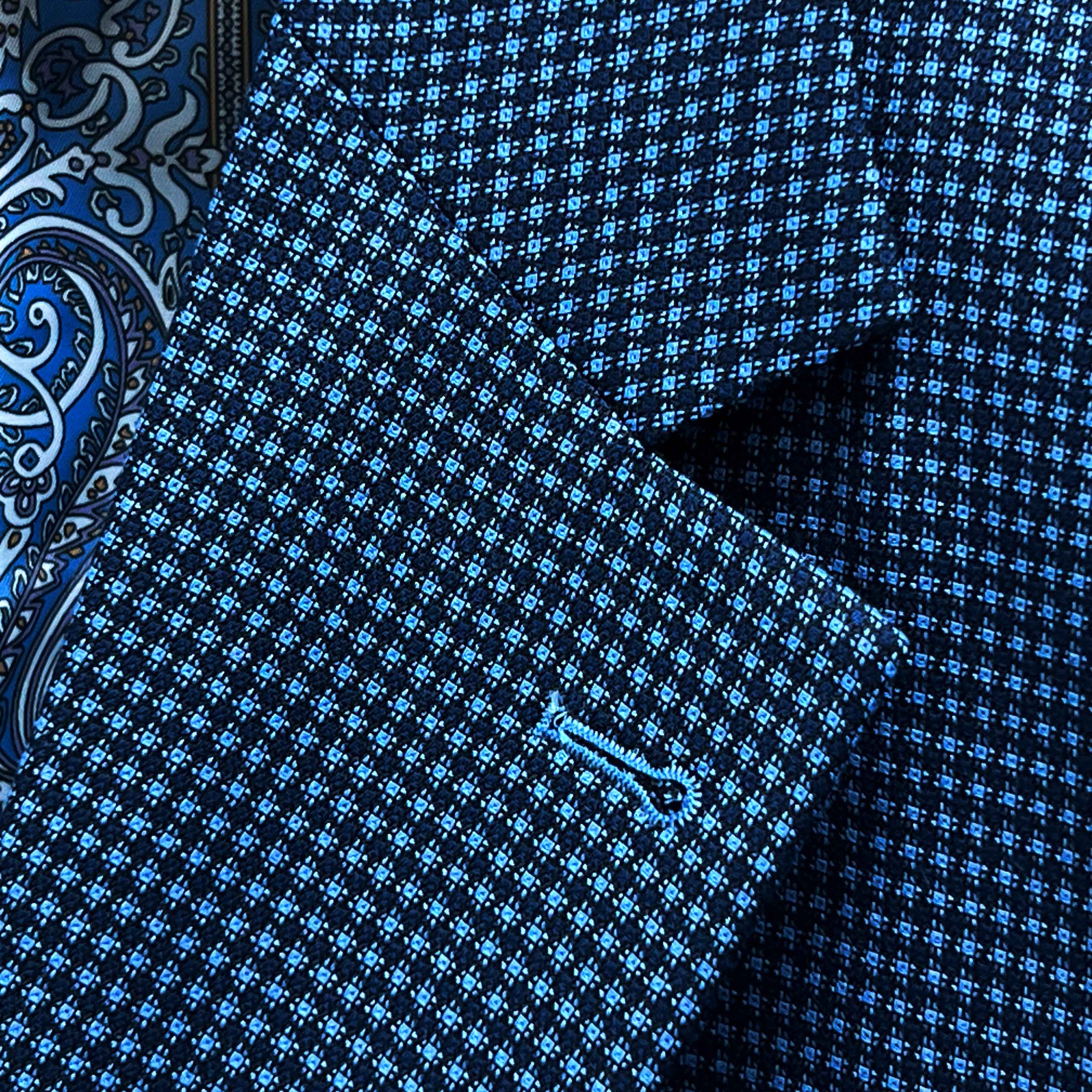 Classic notch lapel detail on medium blue micro check sport coat showing hand pick stitching and navy geometric pattern