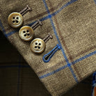 Detail shot of sport coat sleeve cuff, highlighting functional buttonholes with blue contrast stitching