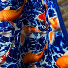 Playful display of sport coat's royal blue lining with swimming goldfish and koi fish pattern