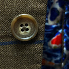 Close-up of sport coat's brown horn buttons, showing natural marbling and texture