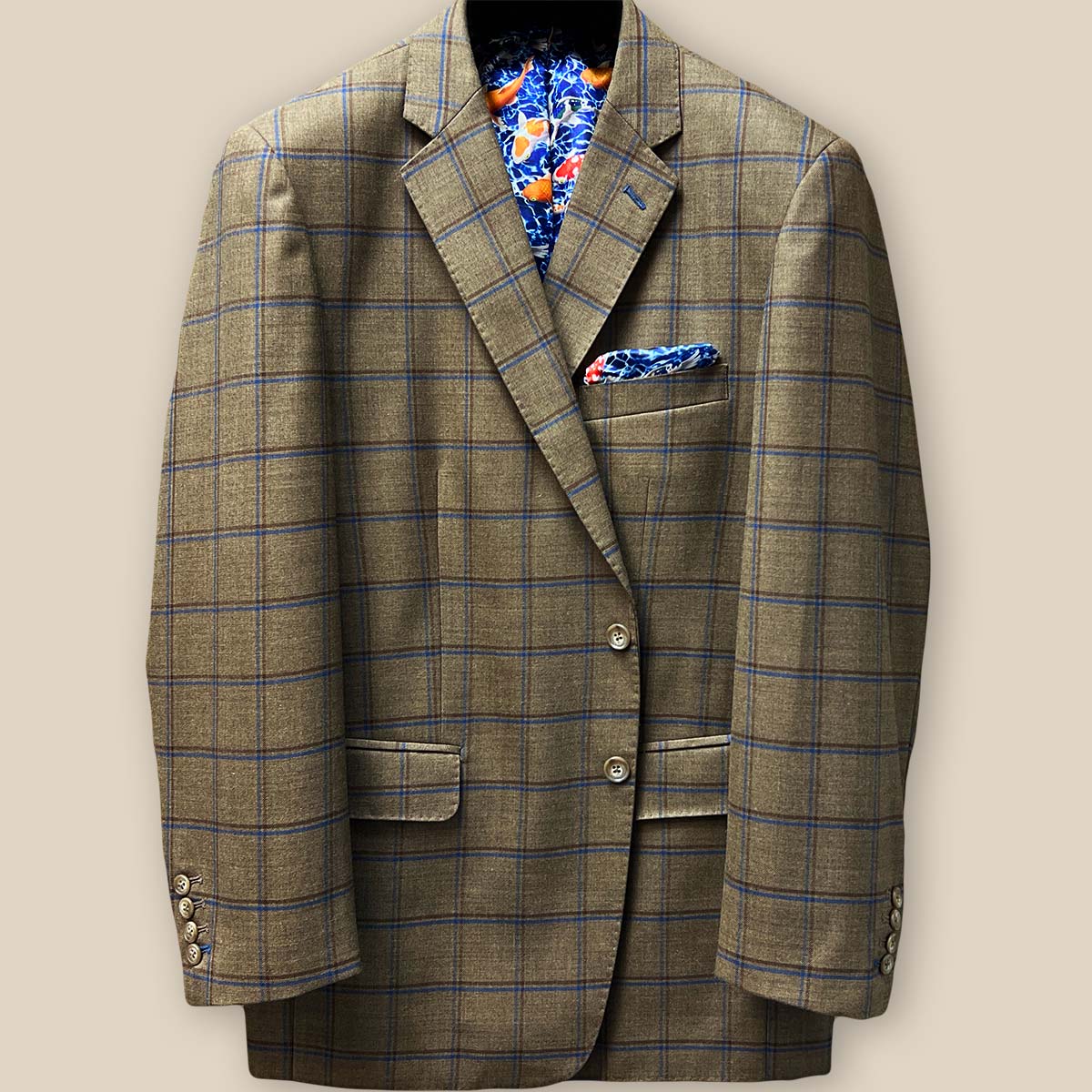 Close-up of sport coat's front, focusing on brown horn buttons and chocolate-blue windowpane fabric