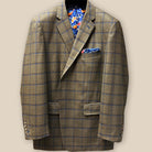 Close-up of medium brown Westwood Hart sport coat sleeve, showcasing blue contrast buttonhole and chocolate-blue windowpane pattern