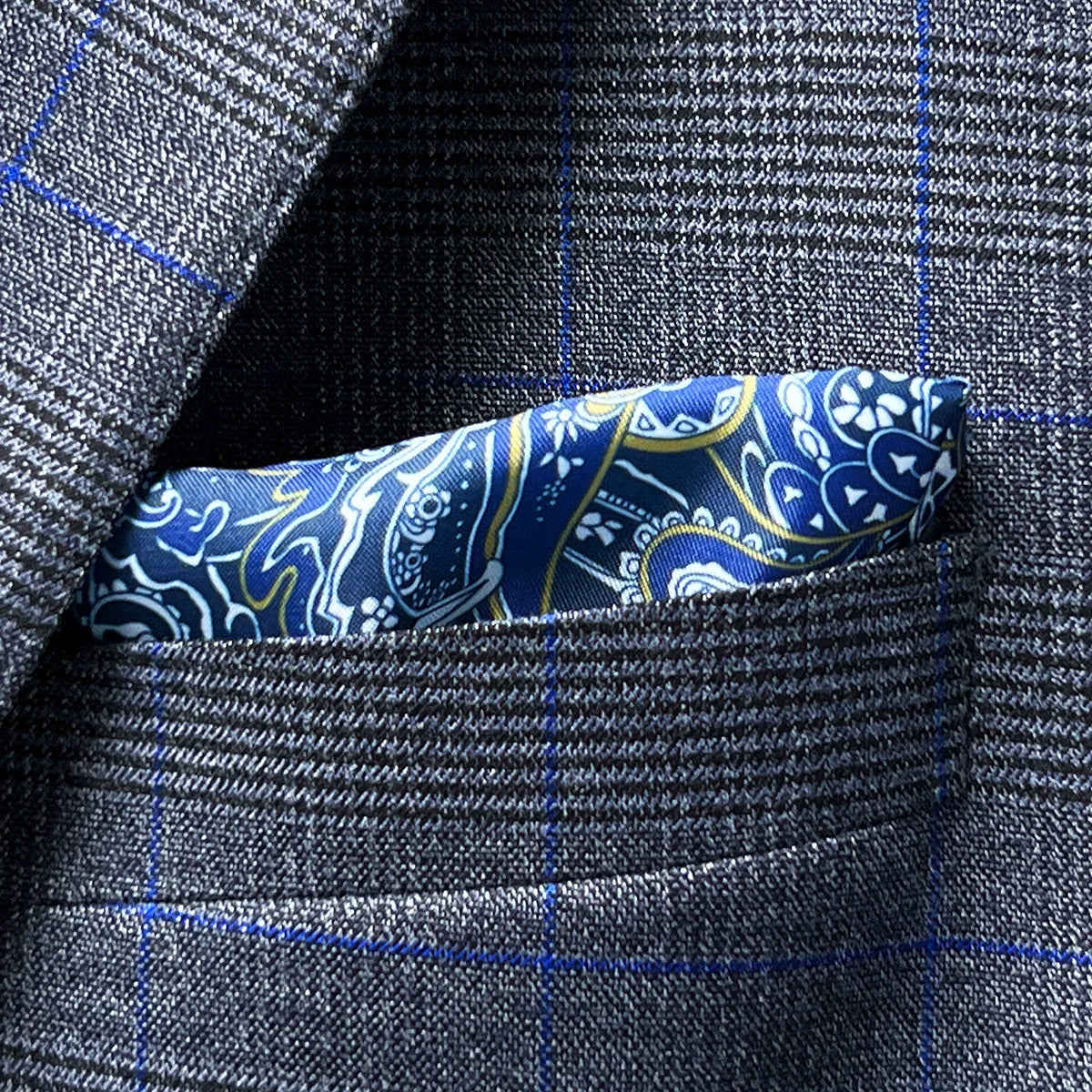 Creative view showing how the blue paisley lining could be fashioned into a built-in pocket square option, complementing the suit's blue windowpane accent