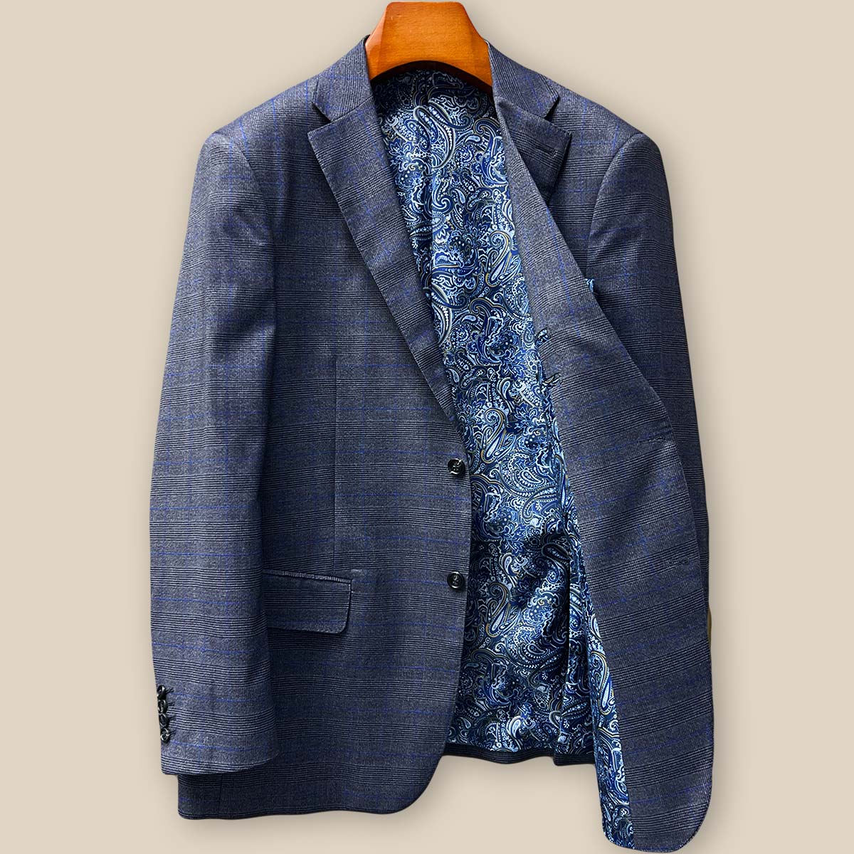 Interior view of the left side of the custom suit jacket revealing the luxurious blue paisley lining with gold and white accents, plus an accessible interior pocket perfect for business cards