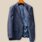 Interior view of the left side of the custom suit jacket revealing the luxurious blue paisley lining with gold and white accents, plus an accessible interior pocket perfect for business cards