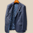 Interior right side view of the bespoke jacket showing additional inner pockets and the continuation of the blue paisley lining with gold and white details