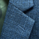 Classic notch lapel detail on medium steel blue hopsack sport coat showing hand pick stitching and hopsack weave texture