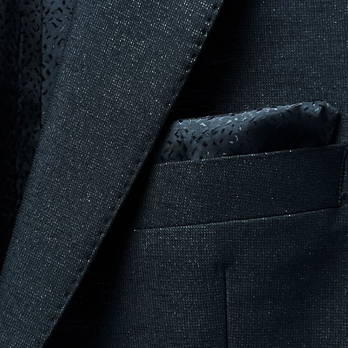 The built-in pocket square on the westwood hart men's shiny black glitter tuxedo jacket, a distinguished feature for formalwear occasions.