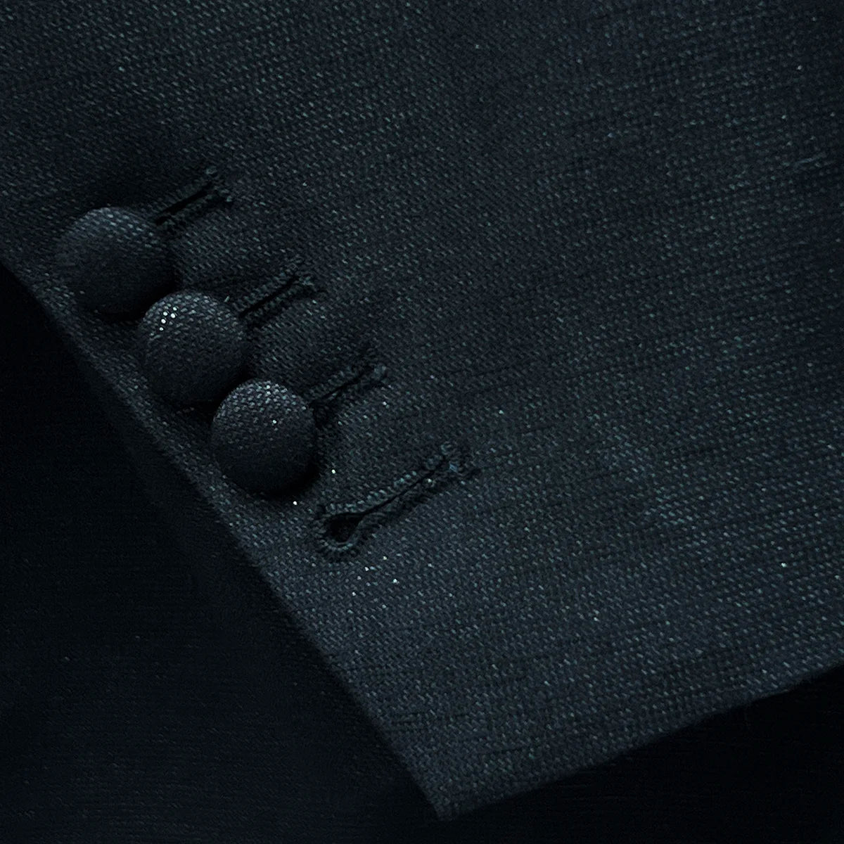 Functional working buttonholes on the sleeve of the westwood hart men's shiny black glitter tuxedo jacket, a hallmark of quality formalwear.