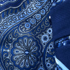 Colorful flash lining detail visible at jacket cuffs and vents in rich blue intricate paisley pattern