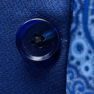 Close-up of navy blue horn buttons on geometric textured suit jacket showing natural marble-like patterns