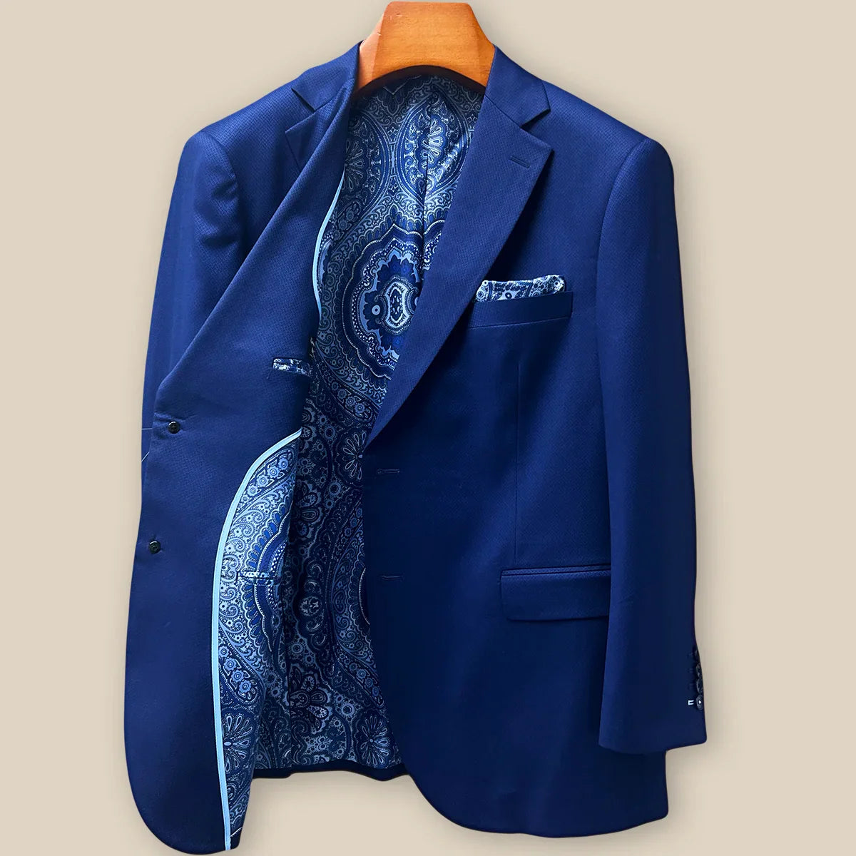 Interior right side of navy blue geometric textured suit jacket revealing paisley lining and internal construction details