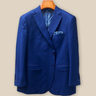 Front button panel of navy blue geometric textured suit jacket featuring navy blue horn buttons and hand pick stitching