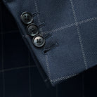 Detail shot of functional buttonholes on suit jacket sleeve, showcasing fine stitching