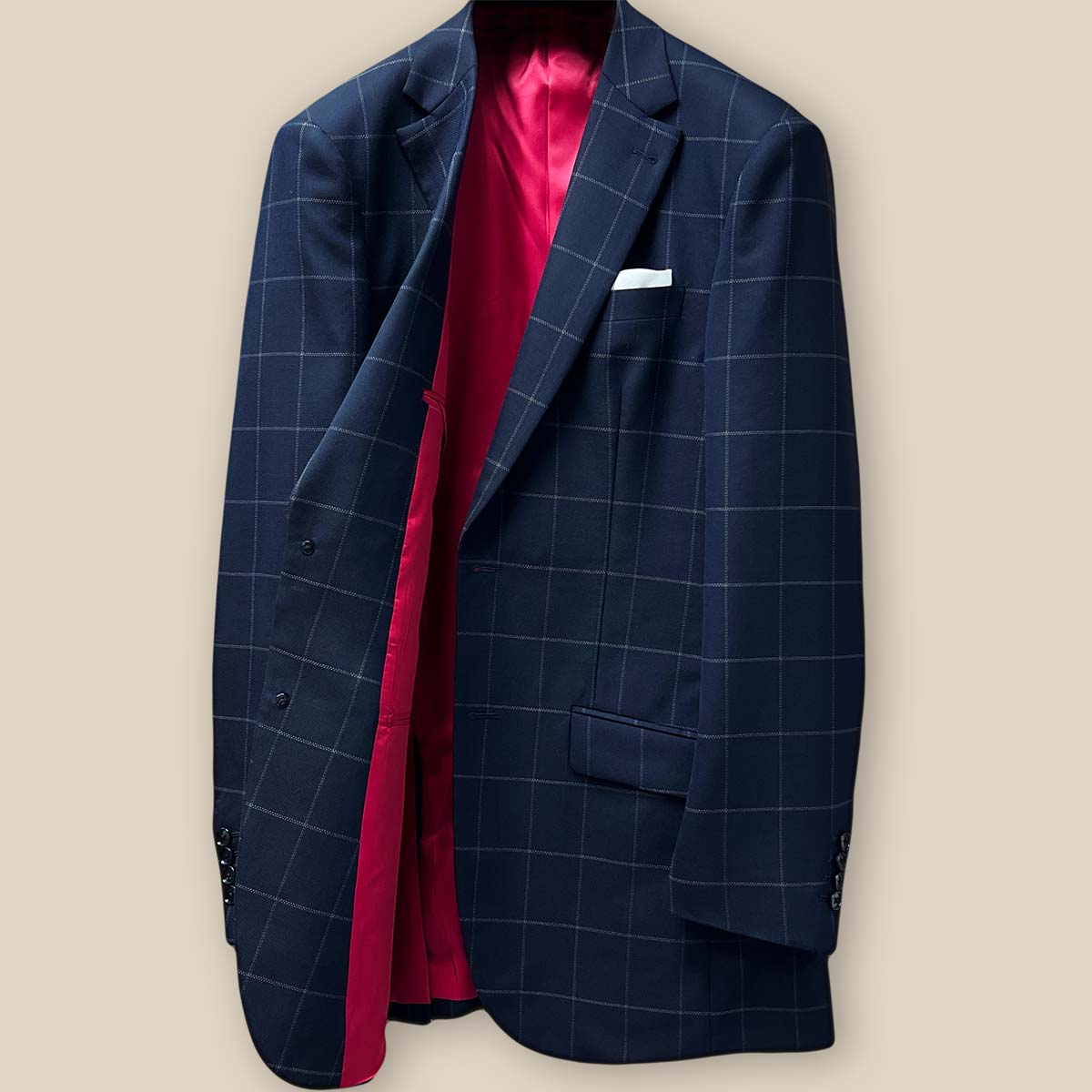 Interior right side of navy windowpane suit jacket, showing inner pockets and brand label