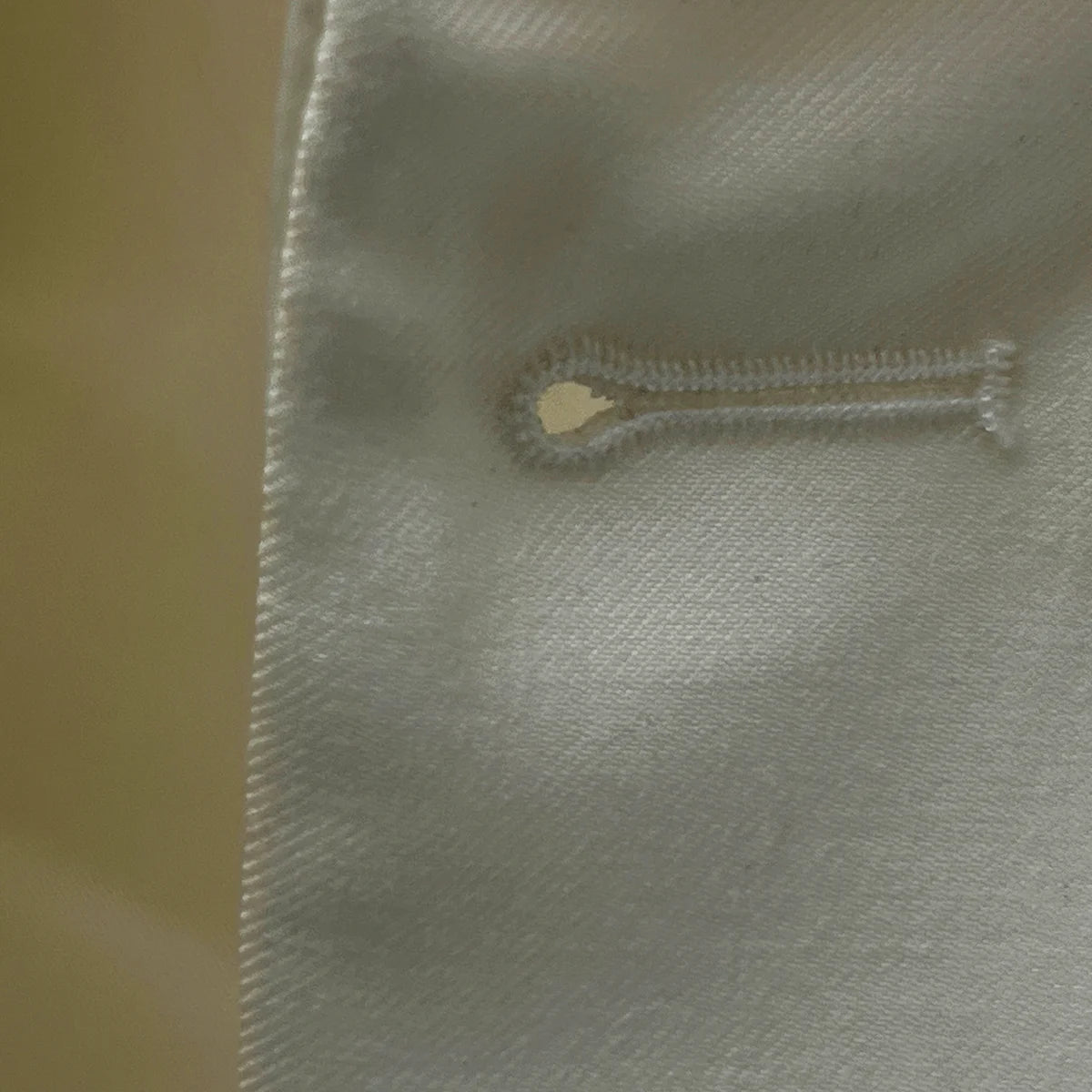 Macro shot of the precise buttonhole stitching on the Westwood Hart dinner jacket demonstrating superior craftsmanship and attention to detail