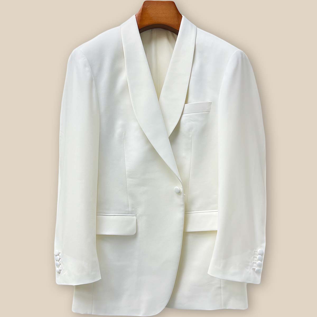 Close-up of the Westwood Hart dinner jacket's front button panel featuring elegant off-white silk satin covered buttons against the Super 130's Australian merino wool