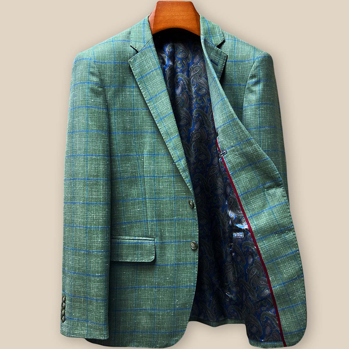 Interior left side view revealing vibrant blue paisley flash lining with contrasting maroon piping and inner pocket construction
