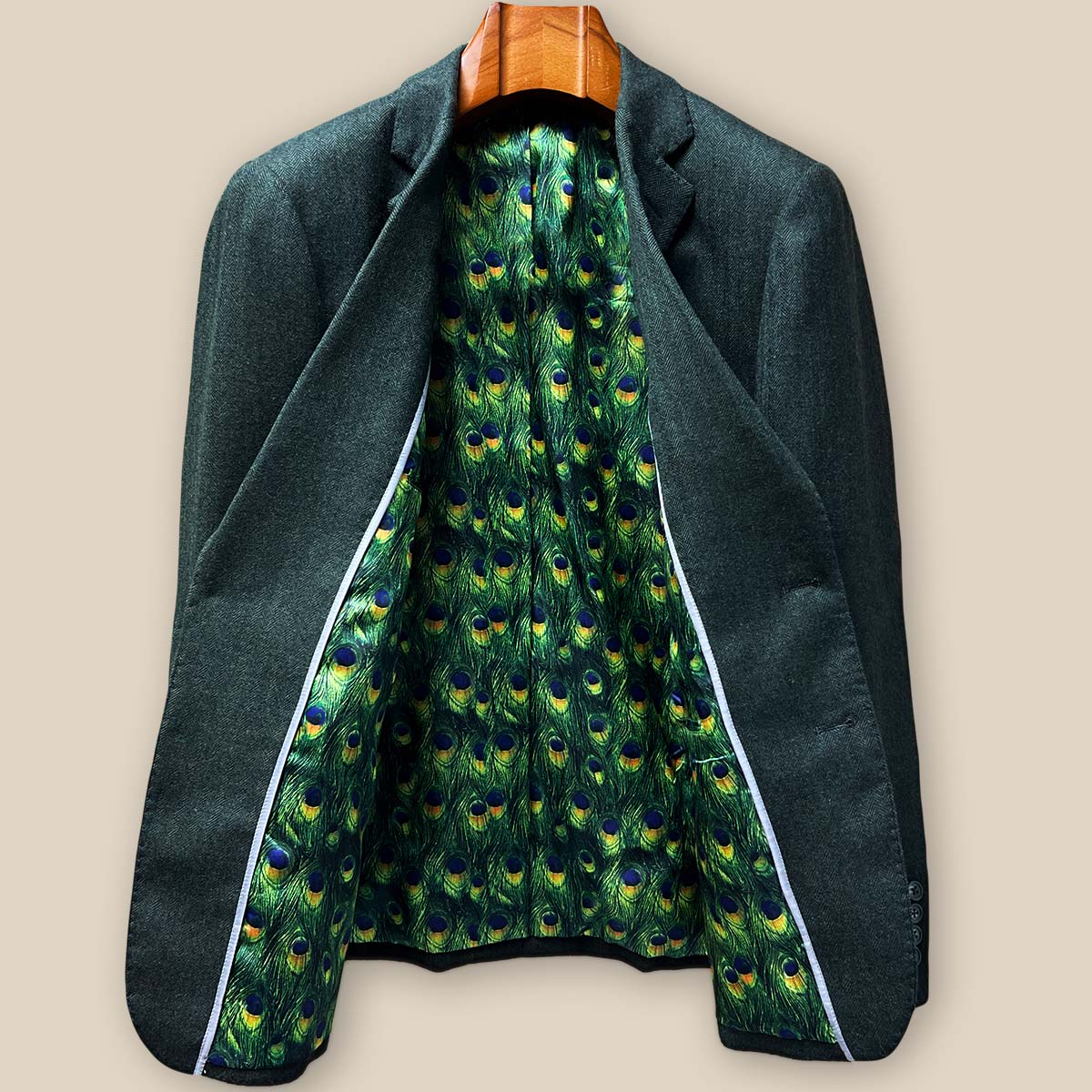 Full view of stunning green peacock feather fancy lining in custom olive herringbone tweed sport coat showing intricate pattern detail