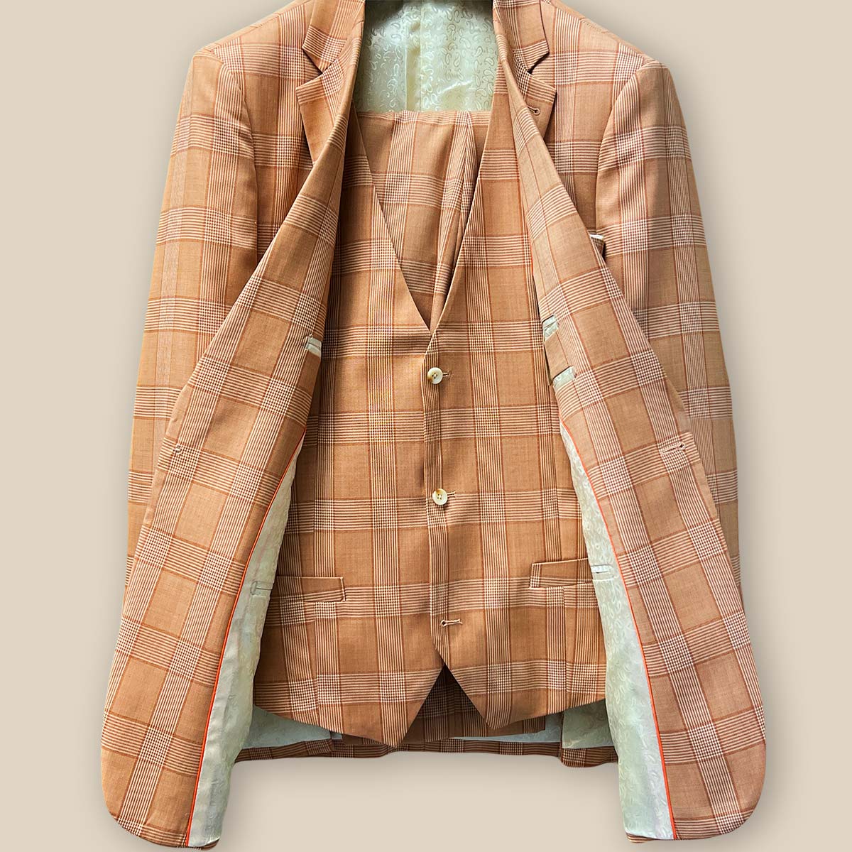 Full front view of orange Prince of Wales glen plaid three-piece suit, showcasing jacket, vest, and trousers