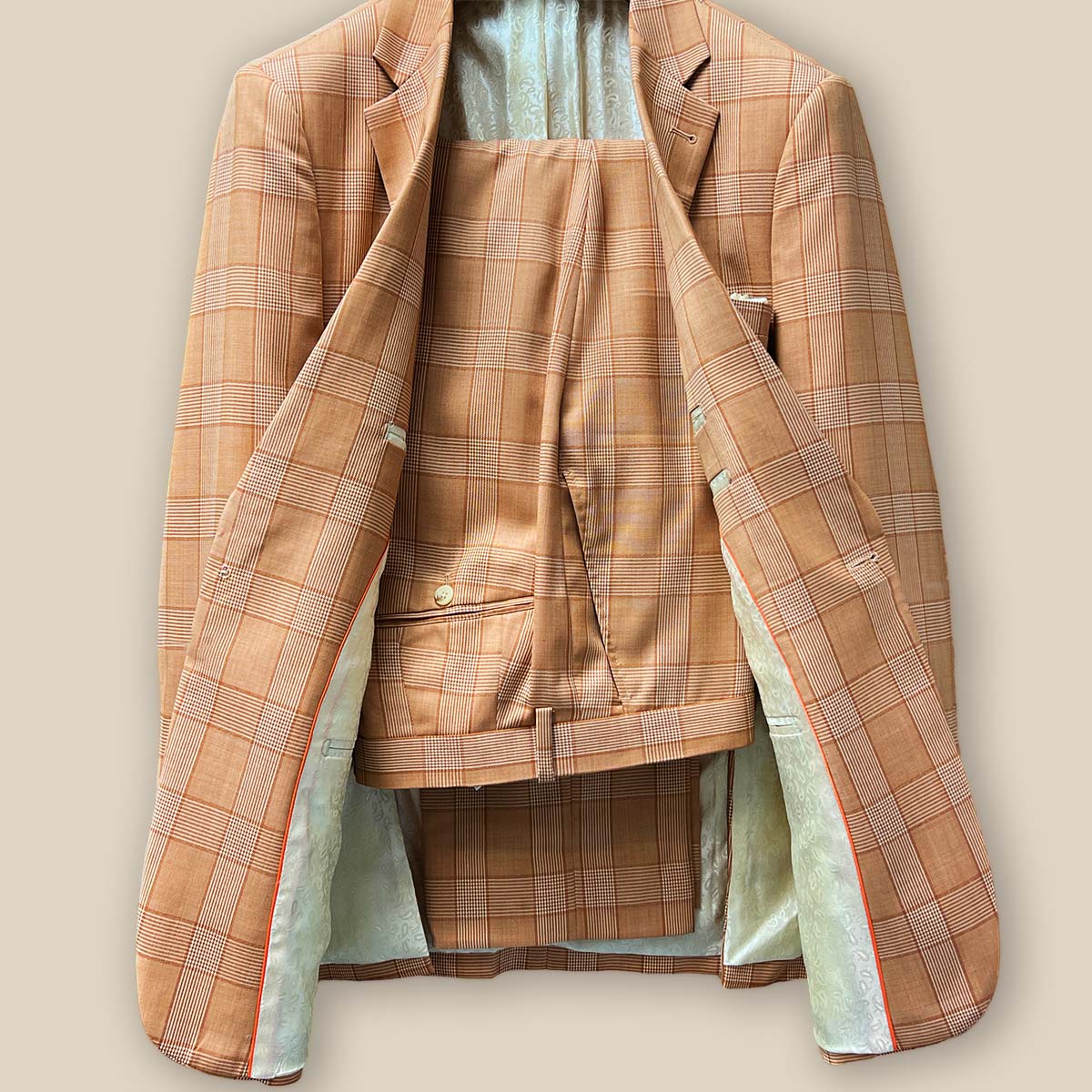 Front view of orange Prince of Wales glen plaid two-piece suit with one-button jacket and matching trousers