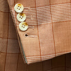 Detail shot of jacket sleeve showing slanting functional buttonholes with ivory marble horn buttons