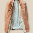 Full interior view of orange suit jacket displaying ivory paisley flash lining and tailoring details