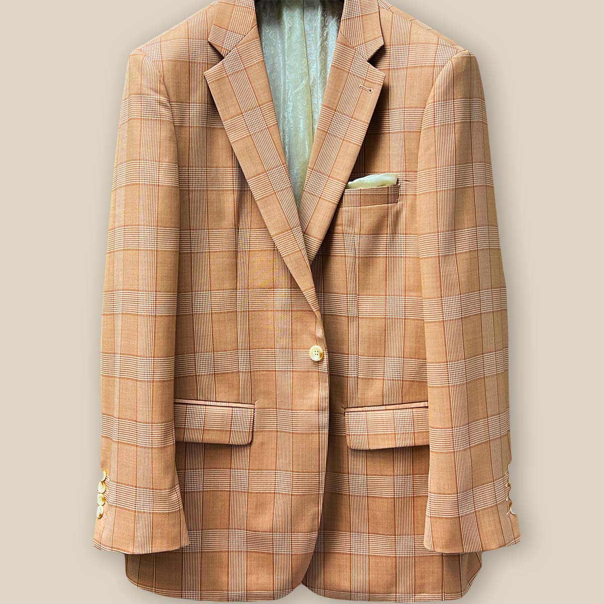 Close-up of suit jacket's front, focusing on single ivory marble horn button and buttonhole