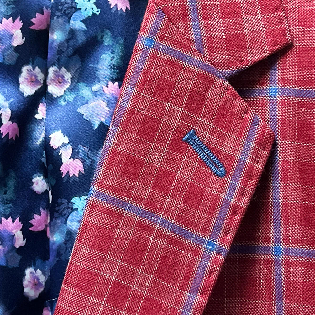 Close-up of the sport coat's notch lapel, showcasing the red with navy windowpane pattern and the navy accent buttonhole.