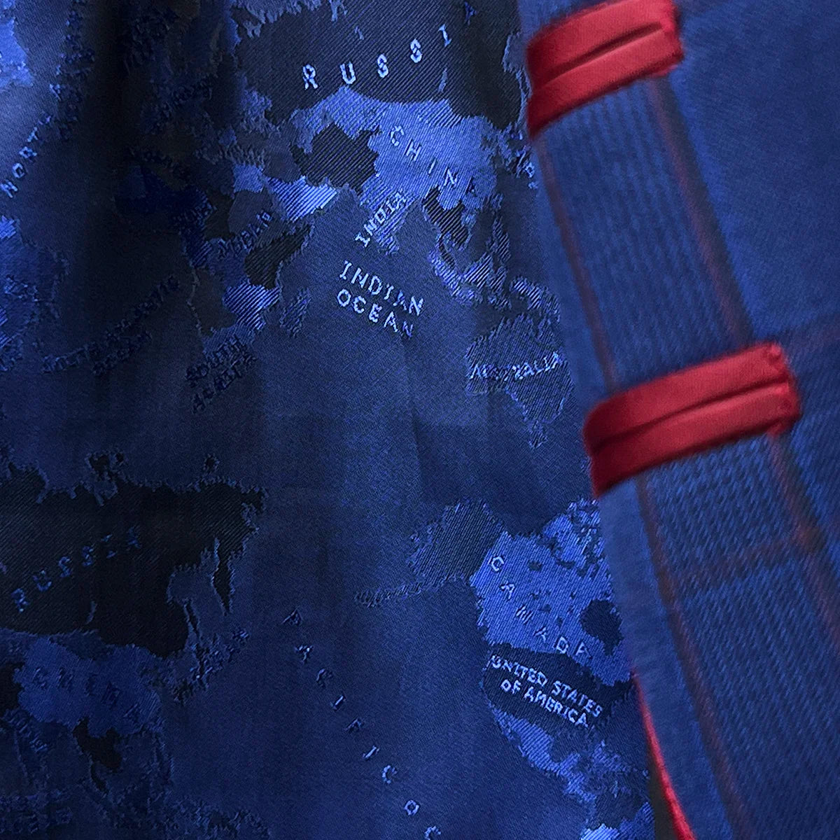 Vibrant navy world geography map flash lining detail creating striking contrast with royal blue exterior fabric