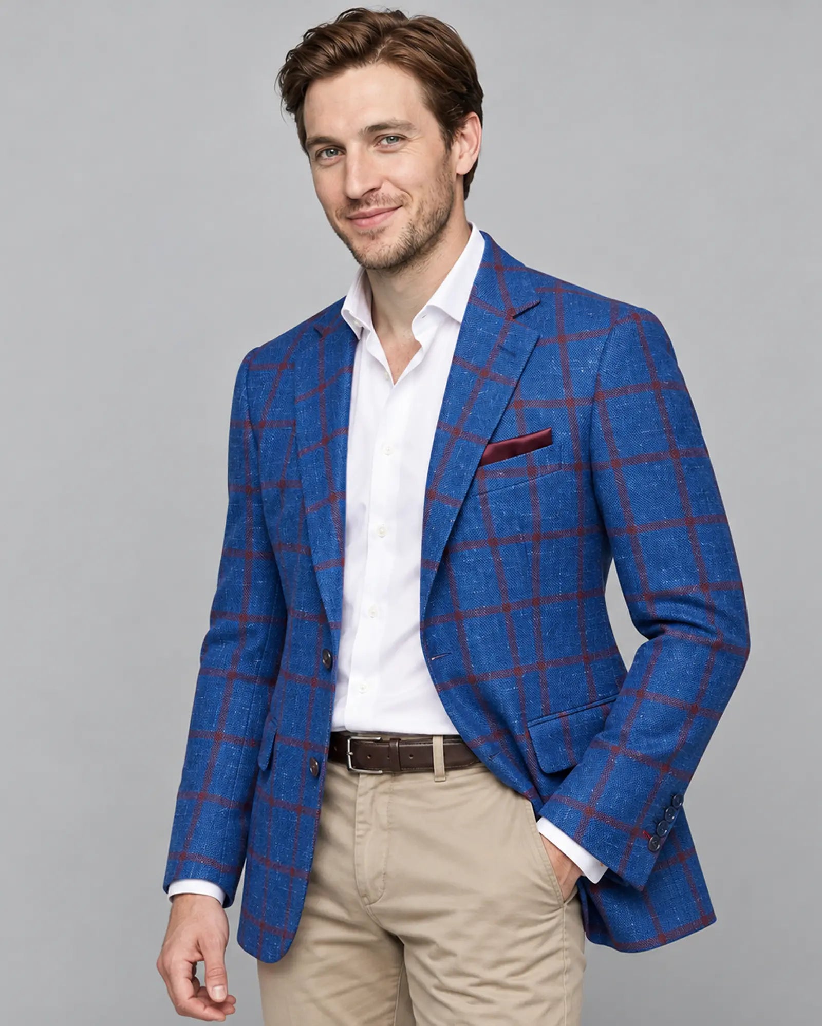 Angled model view of bright royal blue windowpane men's sport coat showing the side profile with a small natural lining glimpse