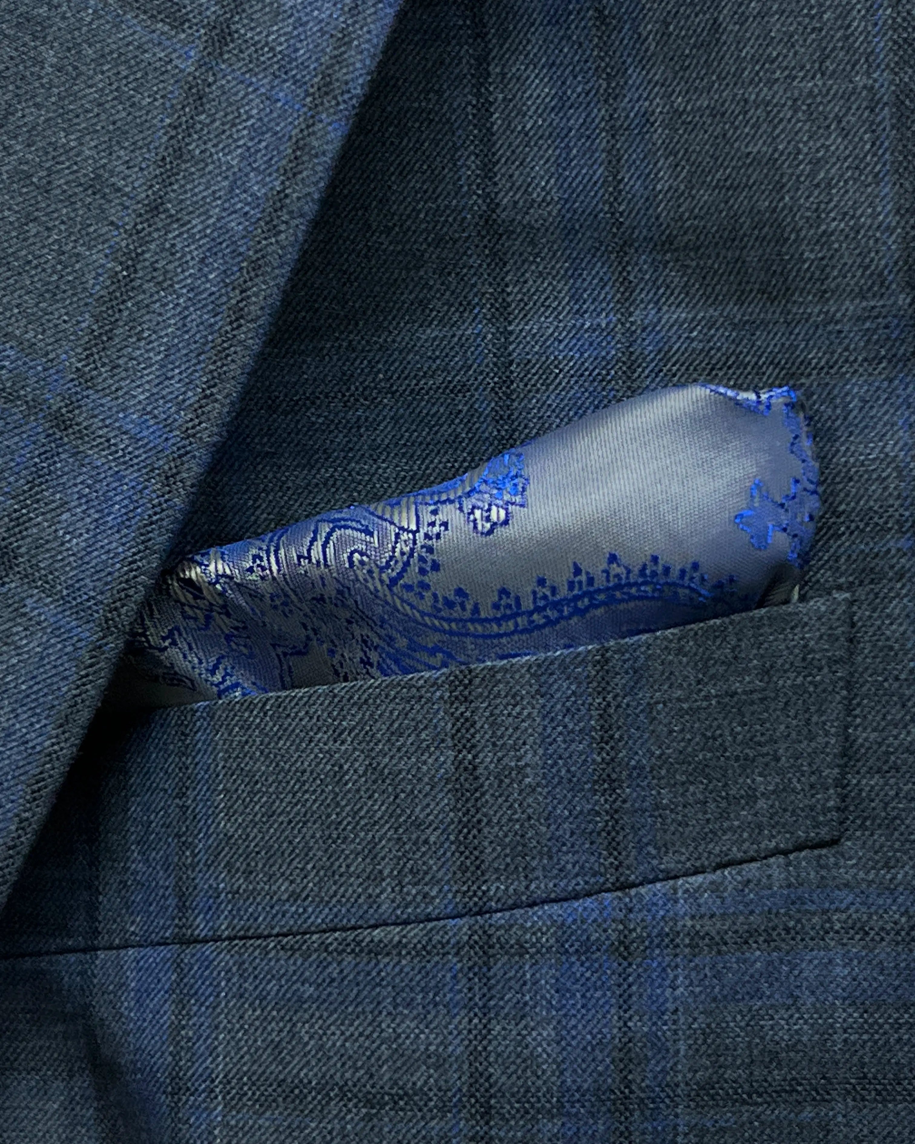 Breast pocket detail of charcoal grey royal blue windowpane men's sport coat showing matching lining pocket square