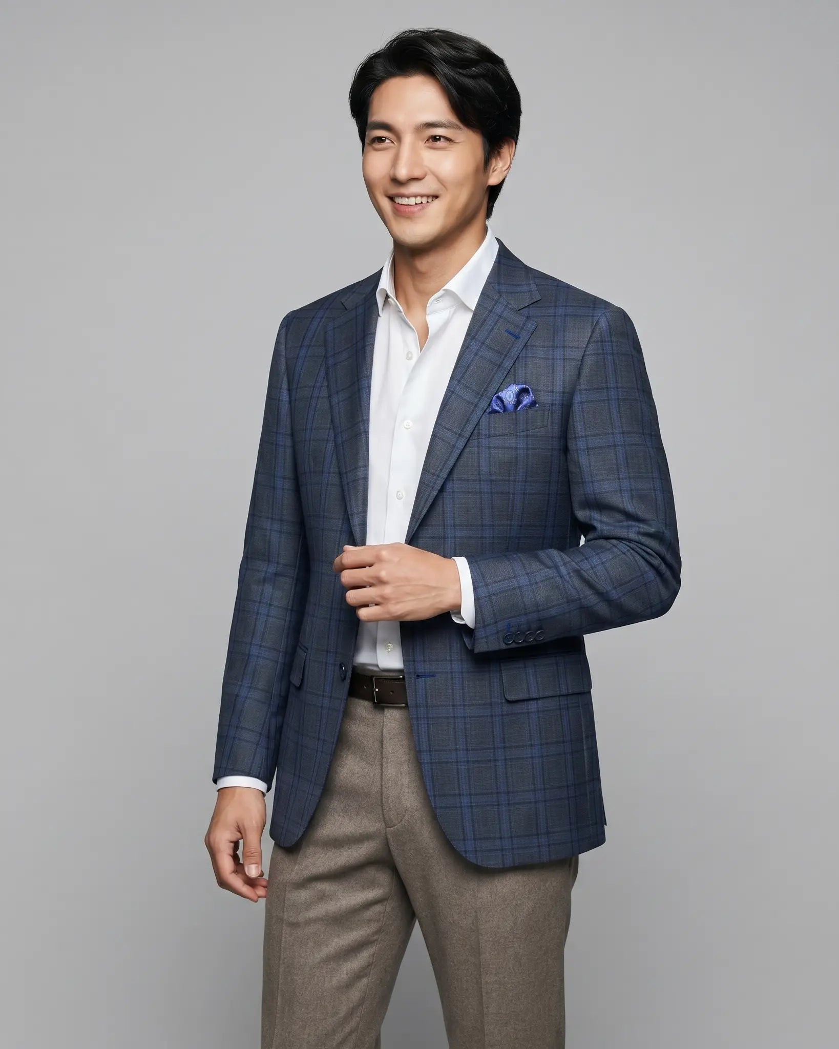 Side model view of charcoal grey royal blue windowpane men's sport coat showing natural drape