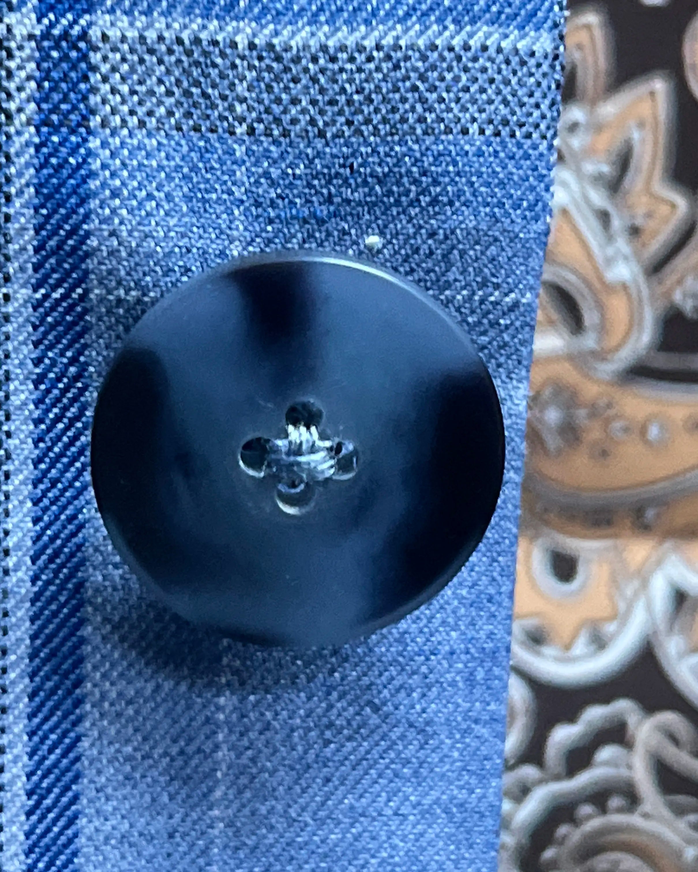 Button detail of Cornflower Blue Windowpane men's sport coat showing dark navy marble horn buttons