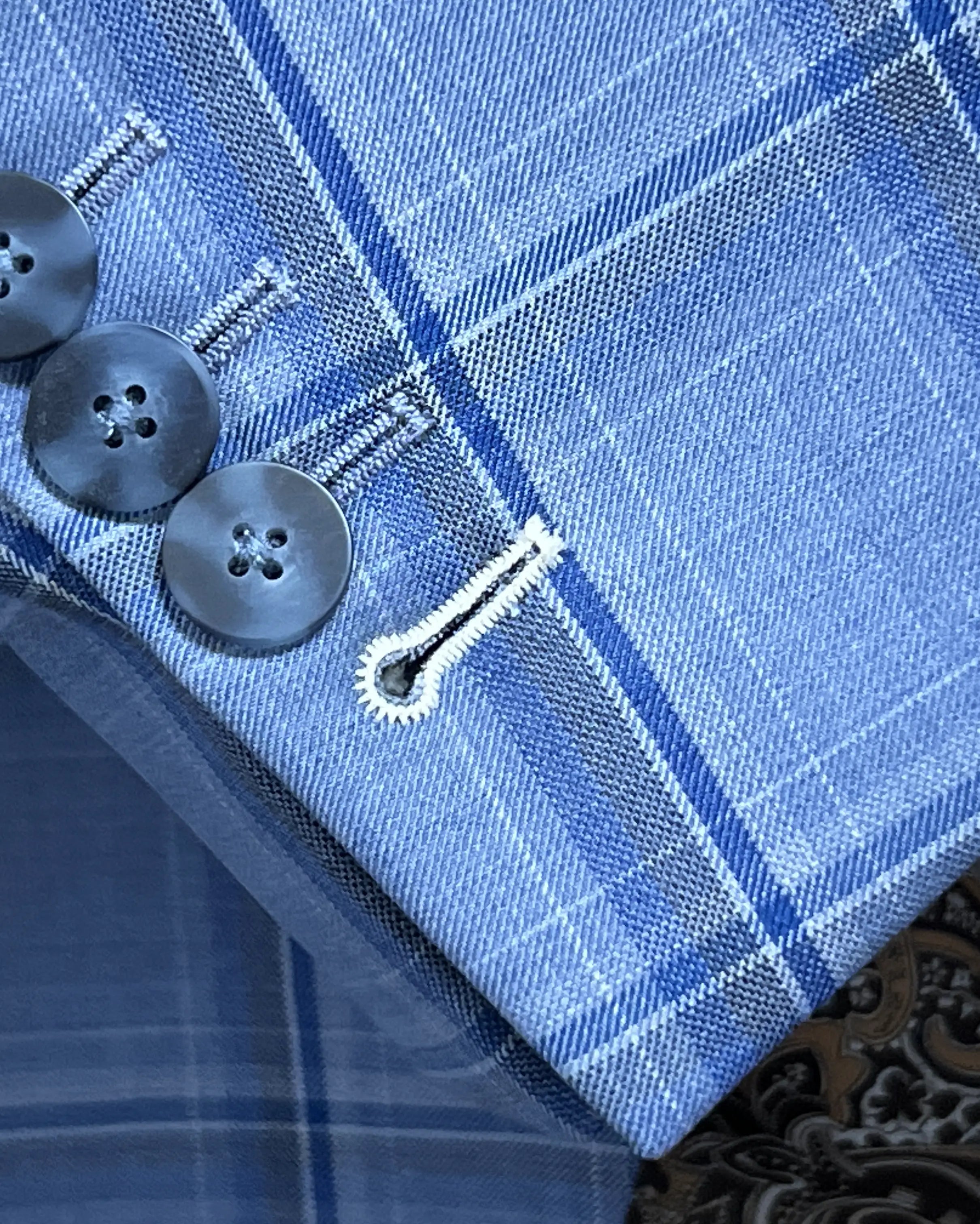 Sleeve cuff detail of Cornflower Blue Windowpane men's sport coat showing functional sleeve buttons with ivory contrast last buttonhole