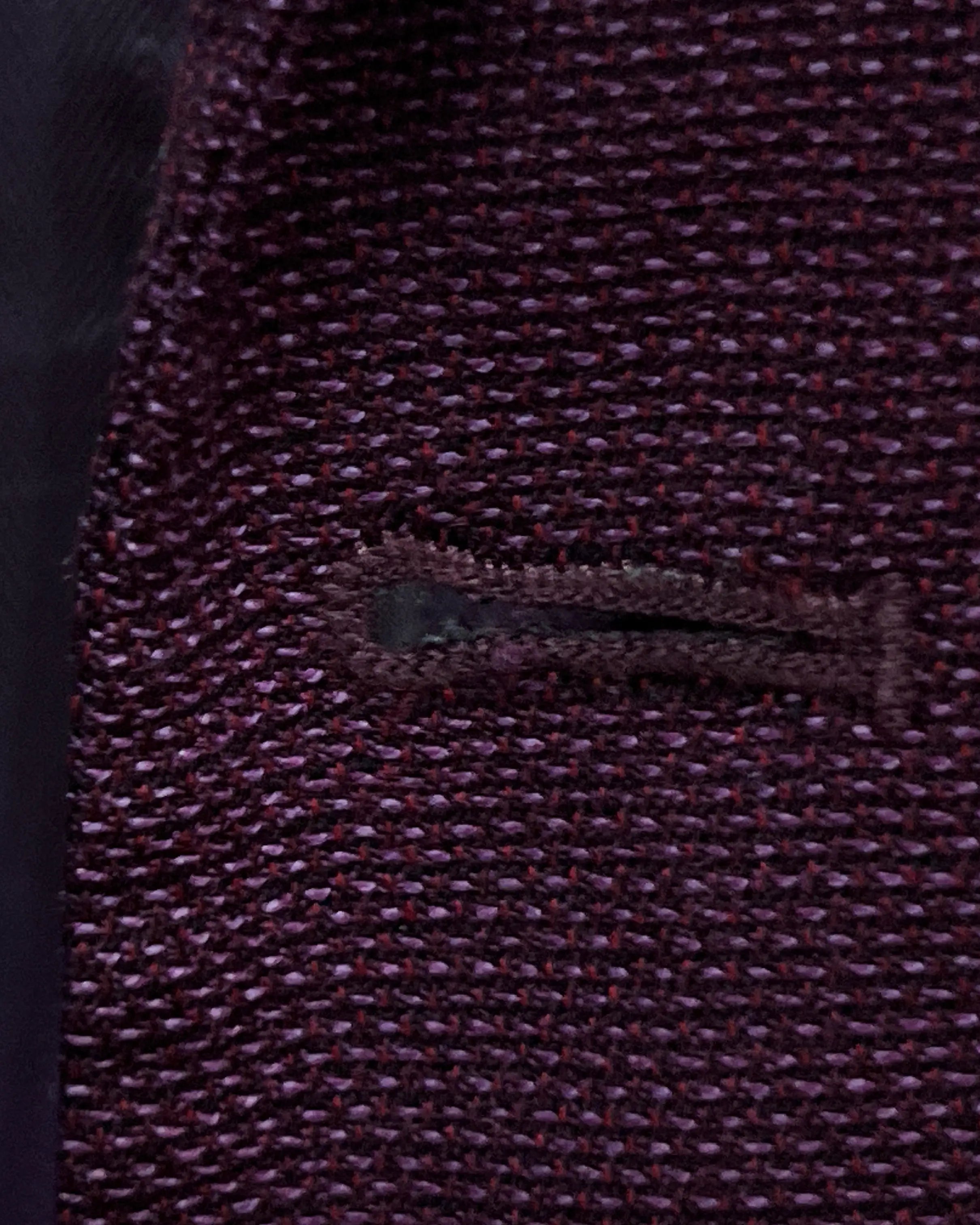 Front buttonhole detail of deep plum burgundy birdseye men's sport coat showing standard buttonhole finishing