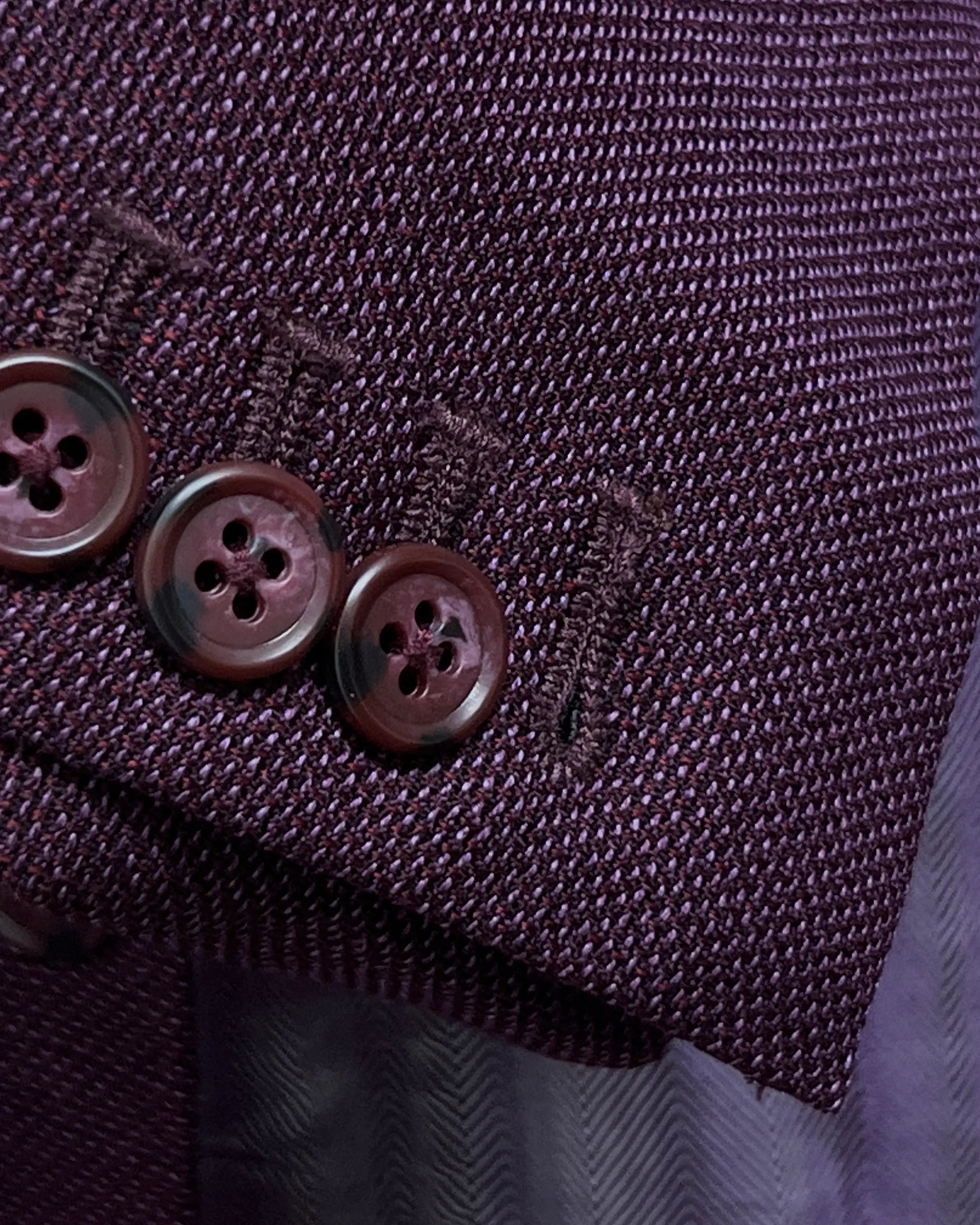Sleeve cuff detail of deep plum burgundy birdseye men's sport coat showing functional sleeve buttons