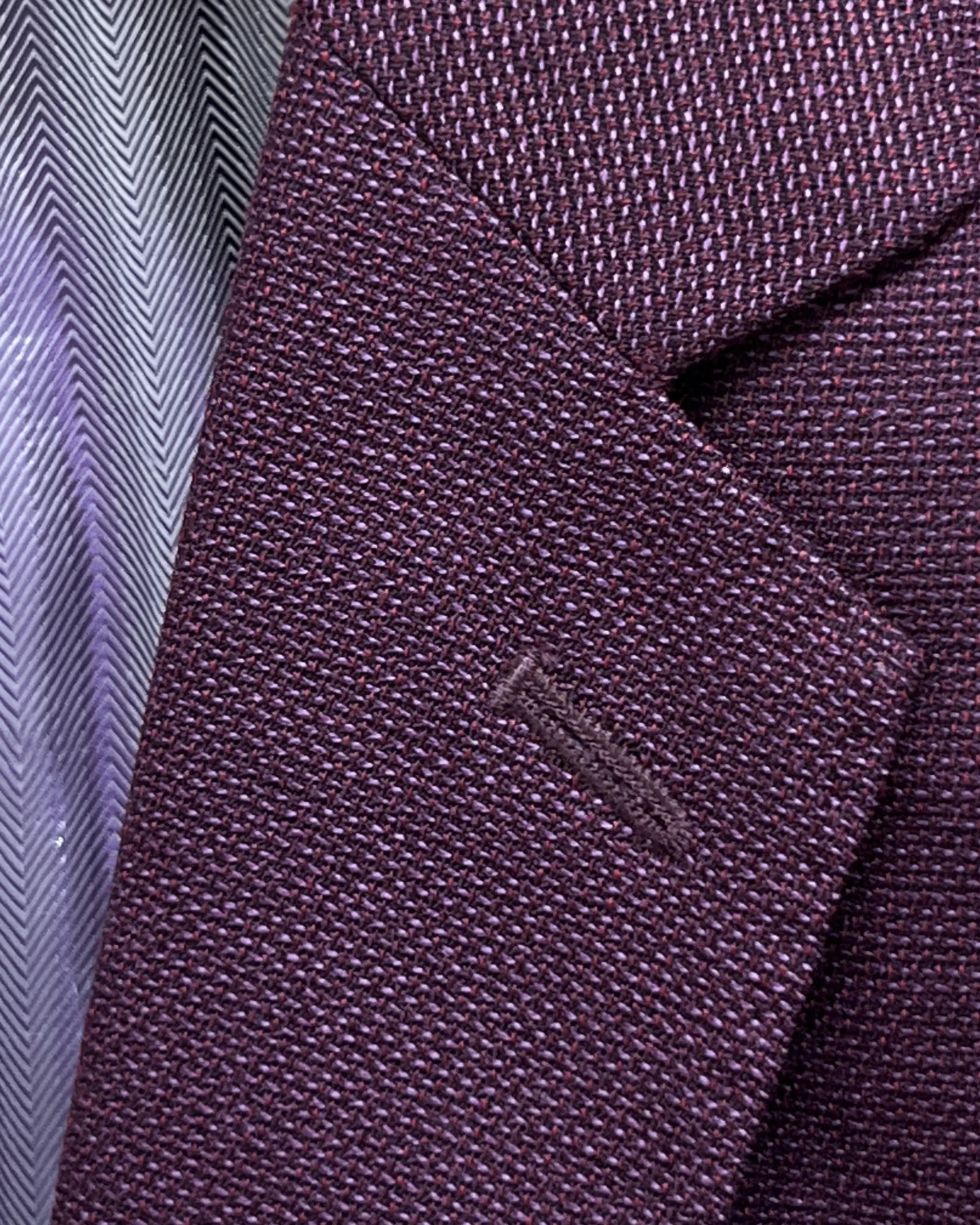 Lapel detail of deep plum burgundy birdseye men's sport coat showing standard lapel buttonhole