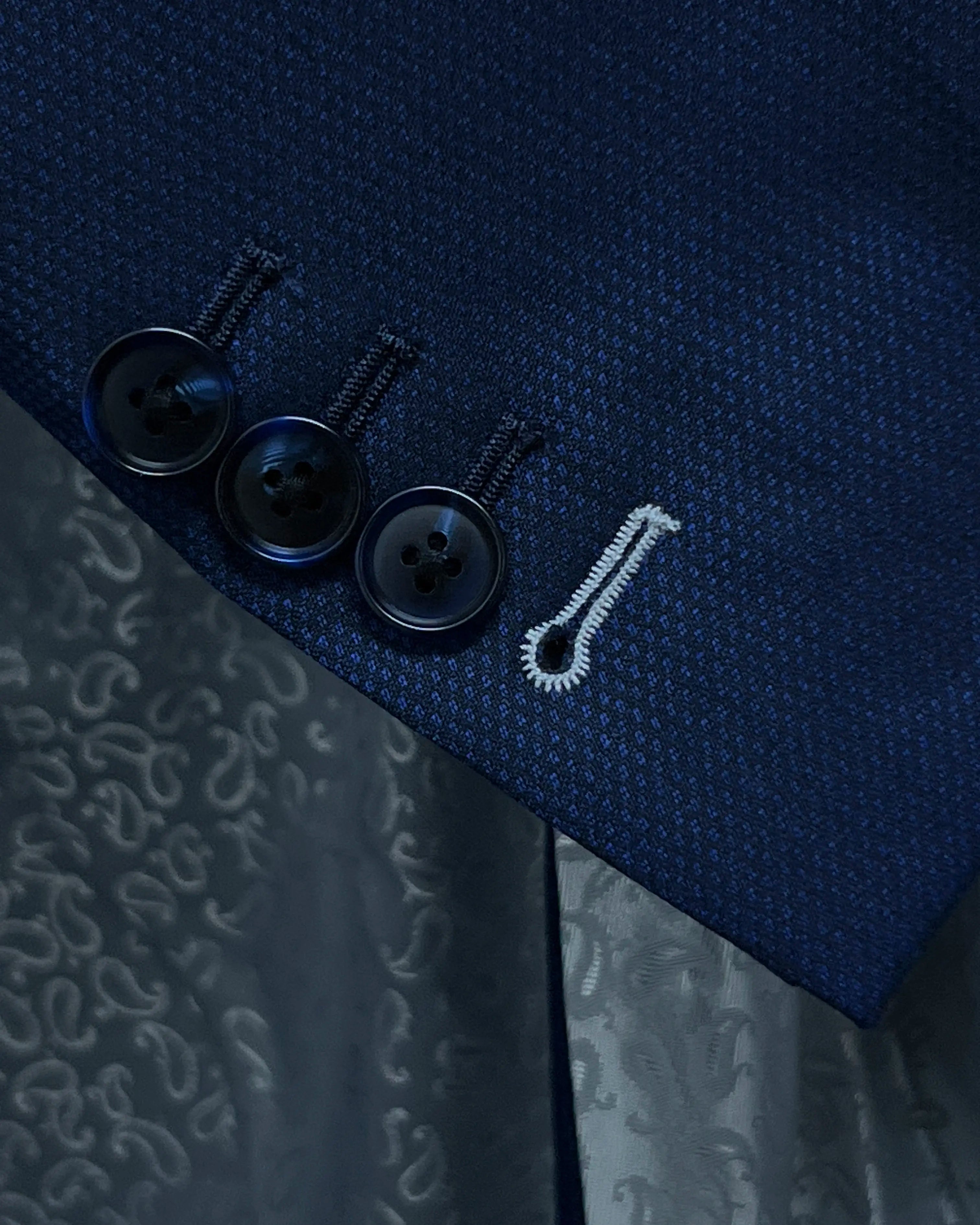 Sleeve cuff close up of Royal blue Birdseye men's sport coat showing the functional sleeve buttons and contrast last buttonhole